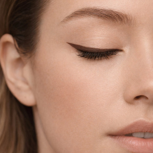 Close-up of eyelid with smooth, precise brown automatic eye pencil finish